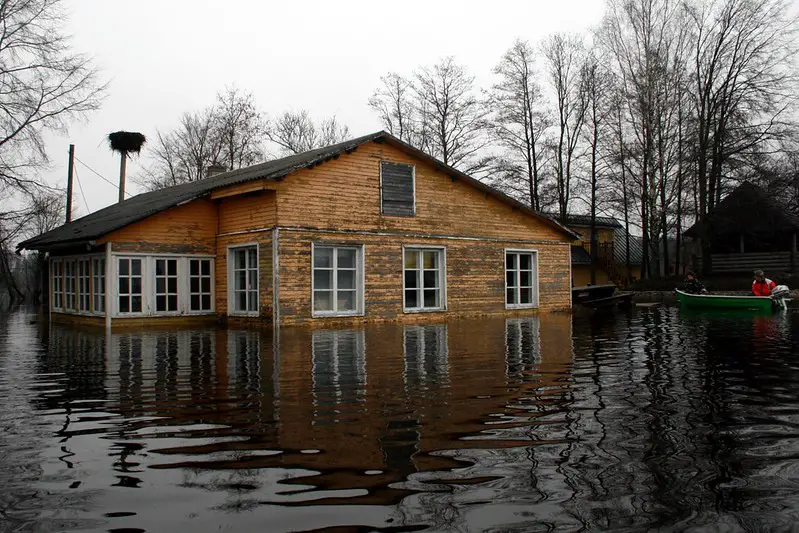 flooded house with rescue boat